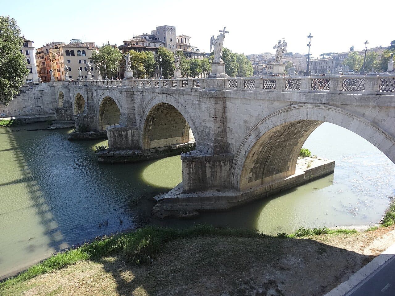 Ponte Sant'Angelo seen from the river bank, showing the three central Roman arches with their original travertine facing