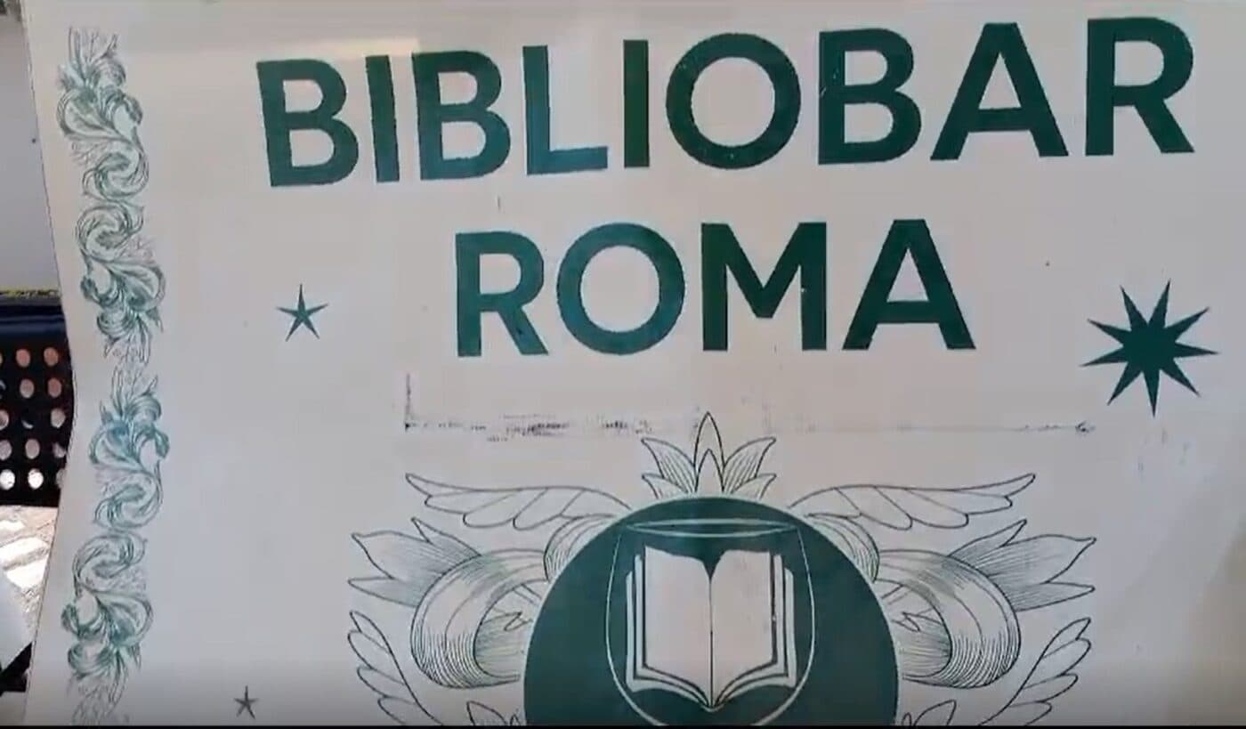 Biblio Bar Roma sign with the bar's logo featuring an open book on a glass