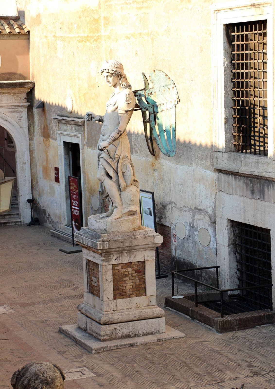 The 1544 marble statue of Saint Michael the Archangel by Raffaello da Montelupo, now standing in the Cortile dell'Angelo at Castel Sant'Angelo. The figure wears a long tunic and is shown sheathing his sword.